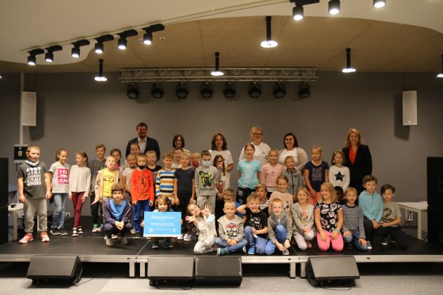 Zdjęcie grupowe uczestników spotkania: przedstawiciele firmy Microsoft, Nauczyciele, dyrekcja szkoły, zastępca burmistrza oraz dzieci