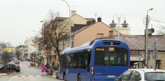 Gmina planuje przebudowę kolejnego odcinka głównej arterii miasta. na zdjęciu ul. Kościuszki, na przejściu dla pieszych kobieta z wózkiem, na drodze samochody i autobus.