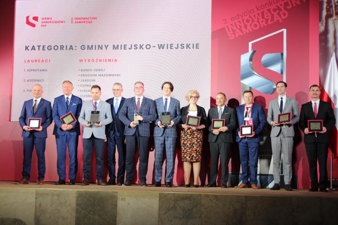 grupa samorządowców na scenie.