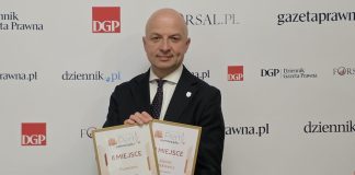 mężczyzna trzyma dwa dyplomy
